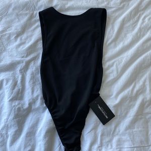 halter bodysuit that shows a little side boob. usa size 4 by pretty little thing